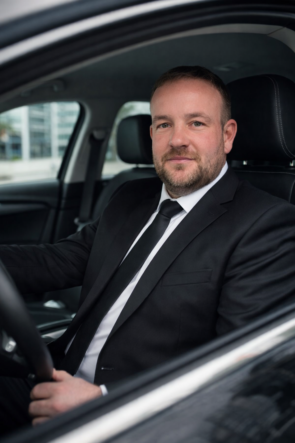 UrbanRide professional chauffeur in car